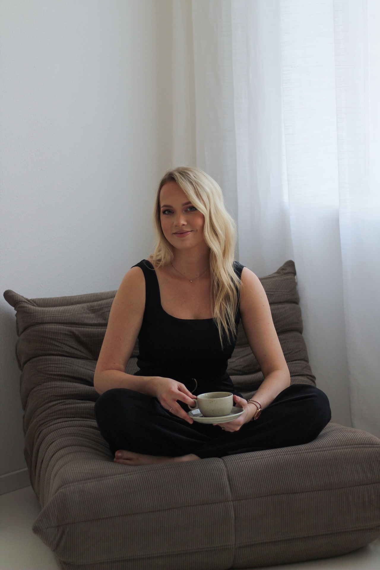 Soft cream interior corner with linen drapery and dried pampas
